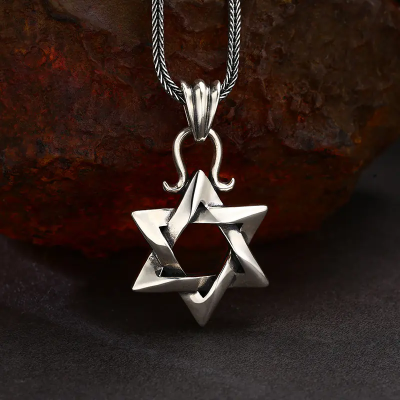 Front view vintage 925 sterling silver twisted Star of David men pendant necklace on rustic stone background