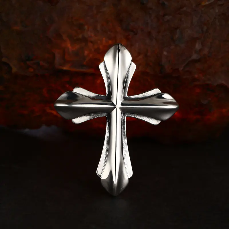 Centered front view chunky 3D 925 sterling silver gothic cross pendant, polished solid cross charm on dark rustic rock backdrop