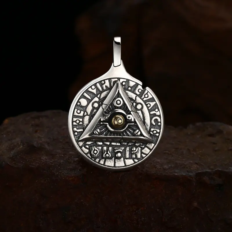 Antique oxidized 925 sterling silver all‑seeing‑eye triangle rune medallion pendant, moody rough rock background occult talisman unisex jewelry