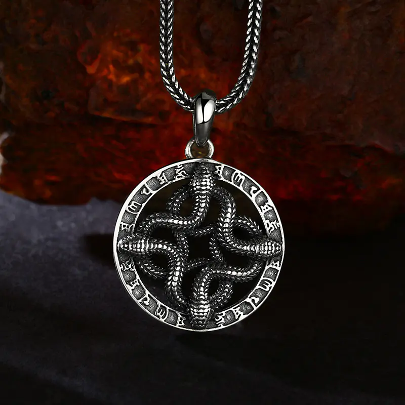 Antique oxidized 925 sterling silver four intertwined snake open‑work rune round pendant, moody rough rock background occult unisex talisman necklace charm