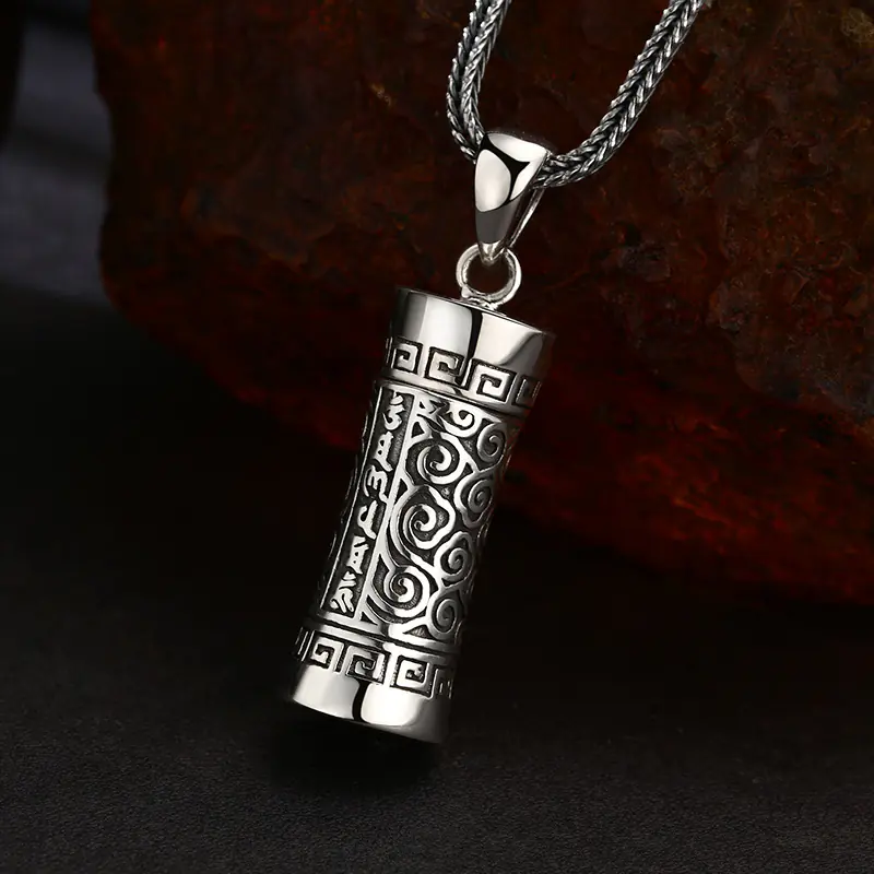 Side angle view 925 sterling silver openable tibetan prayer cylinder gau pendant, deep engraved mantra and cloud scroll patterns, vintage oxidized finish
