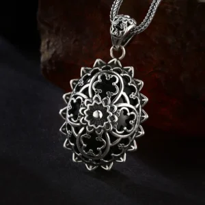 Front‑side angle view 925 sterling silver vintage mandala filigree oval pendant, layered floral openwork with black enamel antique oxidized finish