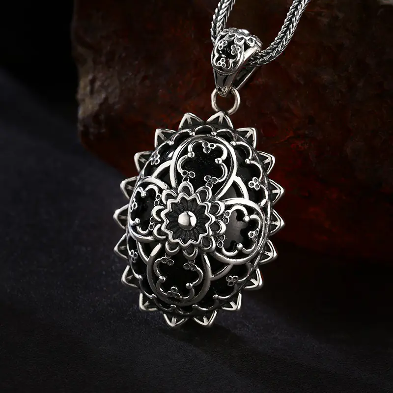 Front‑side angle view 925 sterling silver vintage mandala filigree oval pendant, layered floral openwork with black enamel antique oxidized finish