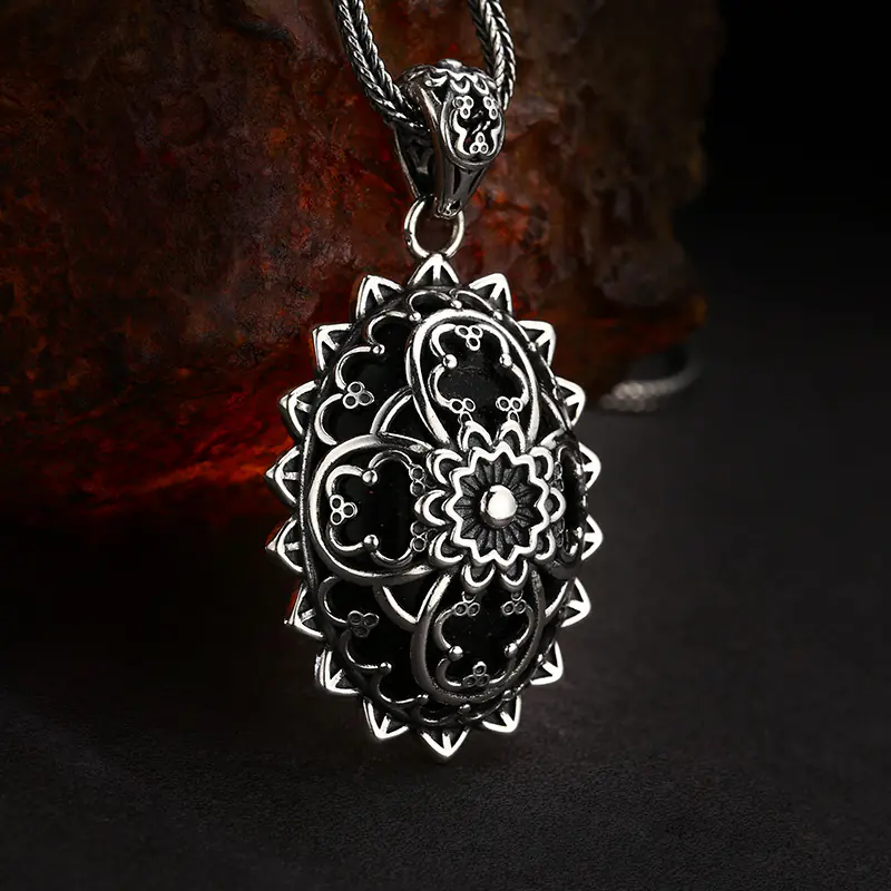 3-925‑silver‑mandala‑filigree‑oval‑pendant‑profile‑side‑view‑texture‑background‑shot.jp Profile side view 925 sterling silver mandala filigree oval pendant, shows pendant thickness, black enamel and vintage oxidized silver filigree edges