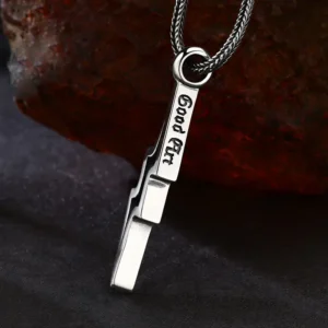 Macro close‑up back view of 925 silver lightning bolt pendant, showing engraved "Good Art" letter mark on bail