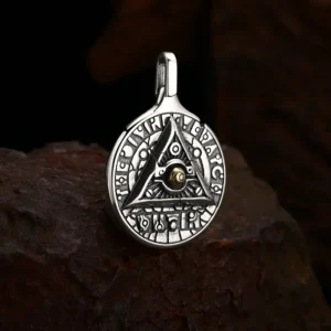 Tilted 3D detail shot 925 sterling silver all‑seeing‑eye rune medallion pendant, antique oxidized finish showing solid thickness and carving depth
