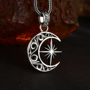 Tilted 3D detail shot vintage crescent moon north star 925 sterling silver pendant, antique oxidized finish showing carving depth and solid thickness