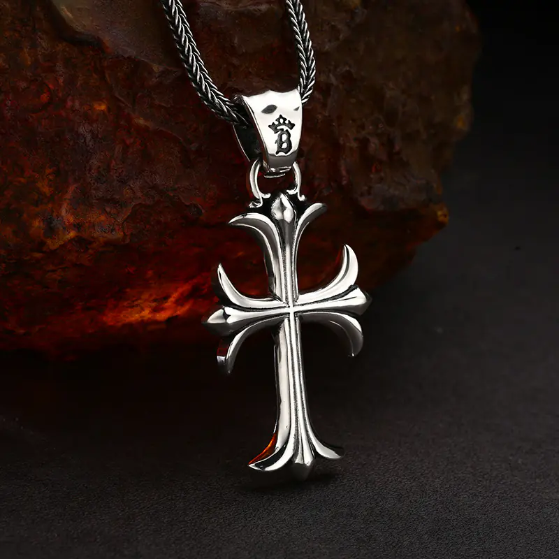 3-vintage‑gothic‑fleur‑de‑lis‑cross‑silver‑pendant‑side‑angle‑hanging‑shot‑rust‑rock.jpg Side‑angle hanging view 925 sterling silver gothic fleur‑de‑lis cross pendant, shows pendant thickness and curved sculpted profile
