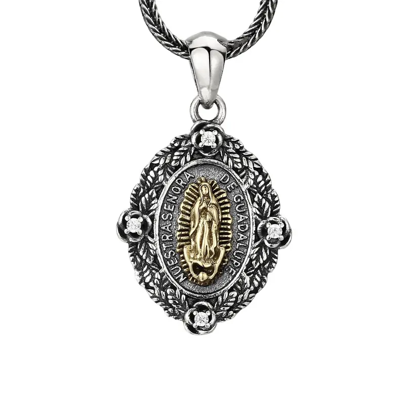 5-925‑sterling‑silver‑our‑lady‑of‑guadalupe‑double‑sided‑oval‑pendant‑white‑background.jpg Two‑tone 925 sterling silver Our Lady of Guadalupe oval pendant, double sided medal with angel back, rose border and tiny clear stones, isolated on white background