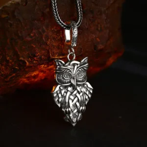 925 sterling silver celtic knot owl pendant displayed with wheat chain on rough stone