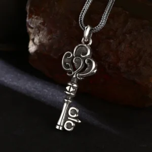 Angled view of vintage scroll pattern 925 sterling silver key pendant