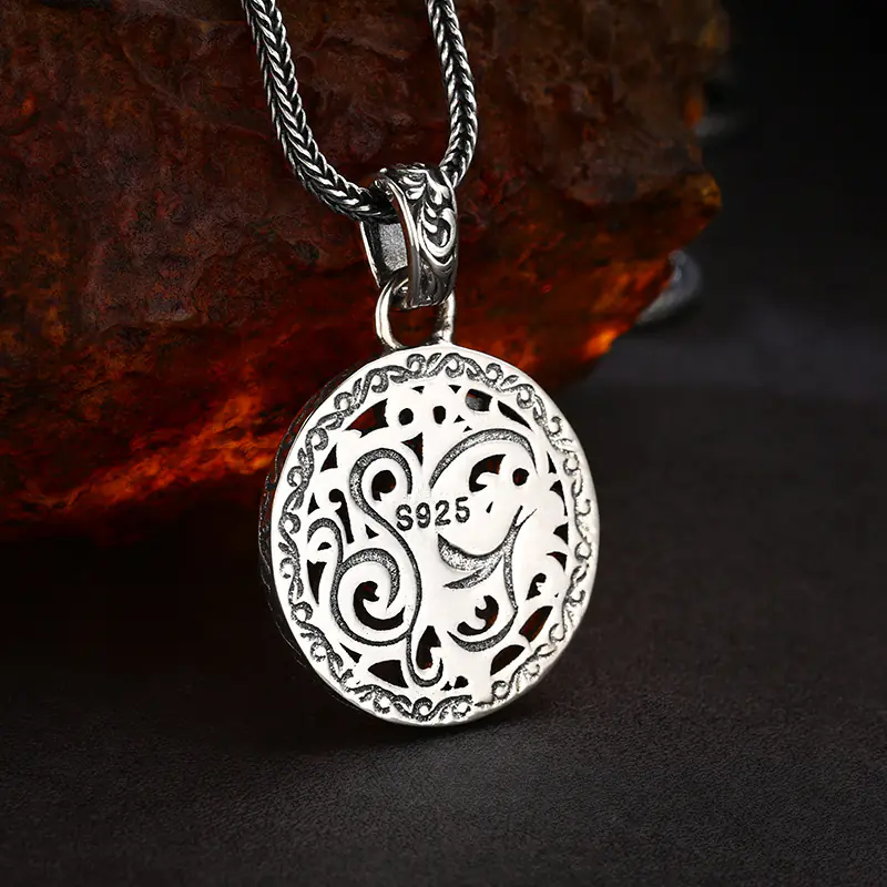 4-925‑sterling‑silver‑vintage‑openwork‑compass‑medallion‑pendant‑back‑view‑s925‑hallmark‑rock‑backgro Back view of 925 sterling silver vintage open‑work compass medallion pendant, intricate scroll cut‑out patterns with S925 hallmark stamp on rustic rock background