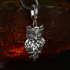 Atmospheric product shot celtic knot owl sterling silver pendant on rustic stone